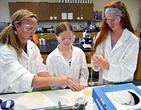 Three students working in lab