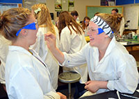 Two students practicing labwork