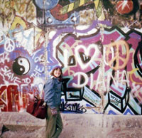 Woman standing by Berlin Wall