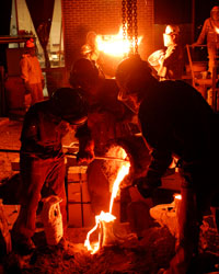 People working with molten iron