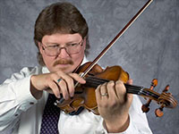 close up of man playing violin