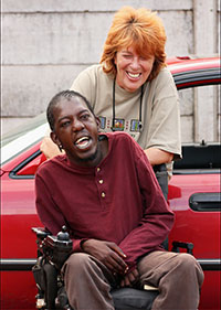 woman pushing young man in wheelchair 