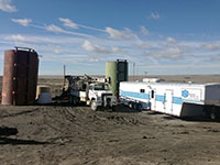 truck, trailer and oil tanks in desert area