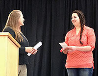 woman presenting award to another woman