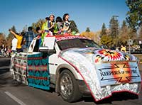 truck decorated with Native American blankets, with Native Americans in traditional clothing