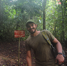 young man in front of jungle