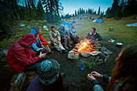 people around a campfire in the mountains