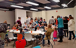 families with children in a room with large tables