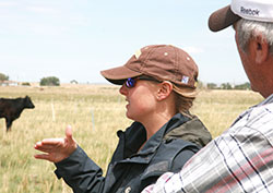 woman standing in field talking to a man