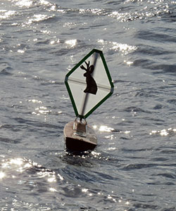 small boat with jackalope sign on it in the water