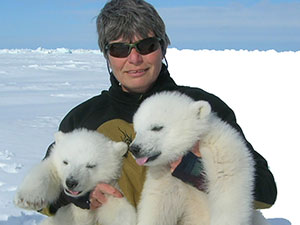 woman holding polar bear cubs