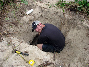 man digging in dirt