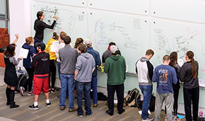 a lot of people at a whiteboard