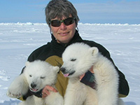 woman holding polar bear cubs