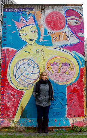 woman standing in front of outdoor mural