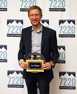 man holding an award