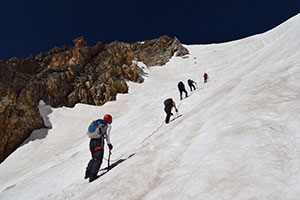 people climbing a snowy mountainside