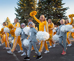 women and girls in track suits carrying pompoms