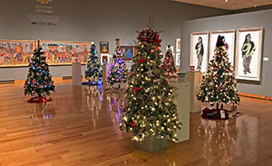 decorated and lit Christmas trees in a large room