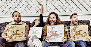 a woman and three men sitting and holding up stylized pictures of birds