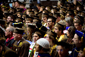 crowd of people in brown caps and gowns