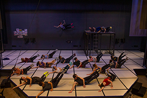 many people on a lying on a stage rehearsing a dance sequence