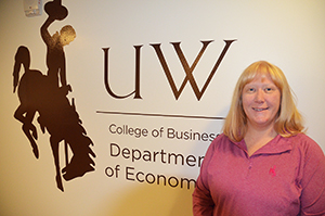 Woman standing in front of a UW sign