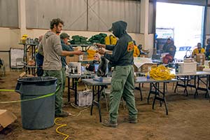 people in a large building putting together supplies