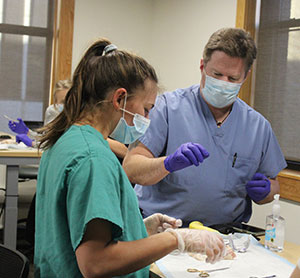 man and woman in scrubs and masks