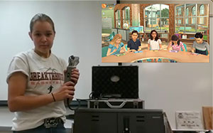 young woman using technical equipment with a screenshot of virtual students