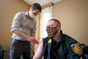 police officer receiving vaccine