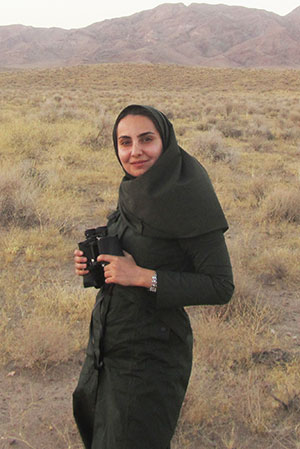 woman standing on plains in front of mountains