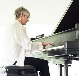 person playing a grand piano