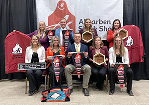 group of people posing in front of a banner