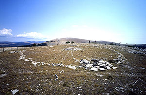 stones arranged in a wheel shape on a hill