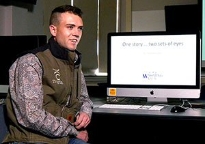 man sitting beside a computer