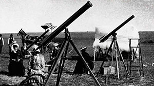 vintage photo of telescopes lined up with people using them