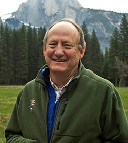 man standing outdoors with a mountain in the background