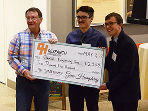 small group of people holding an oversized check
