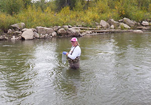 person standing in stream