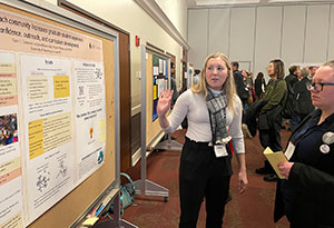 woman explaining a display poster to someone