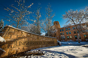 entrance sign to UW with snow all around
