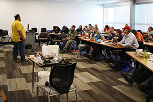 man lecturing to a room full of people