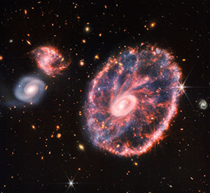 galaxy with spokes in it, along with several other galaxies