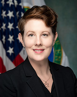 head photo of a woman in front of an American flag