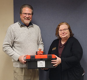 man and woman holding a plastic case