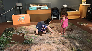 children putting together a huge floor puzzle