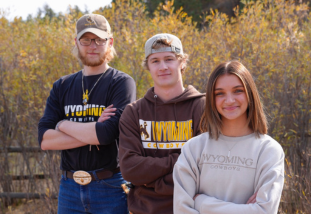 students standing in front of greenery