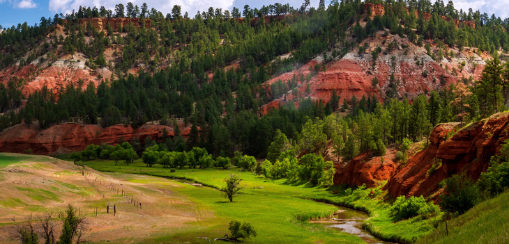 scenic image of red hills over farm land.