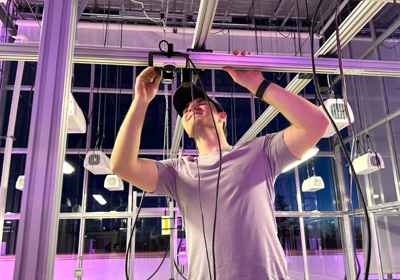 UW undergraduate student Jack McKinley deploys a camera onto a small gantry system at the Plant Growth and Phenotyping Facility. After taking the CEA class in 2024, McKinley has been working for Guadagno and Jian Gong, a research scientist in the School of Computing, to improve data collection in CEA. Photo courtesy of Carmela Guadagno.